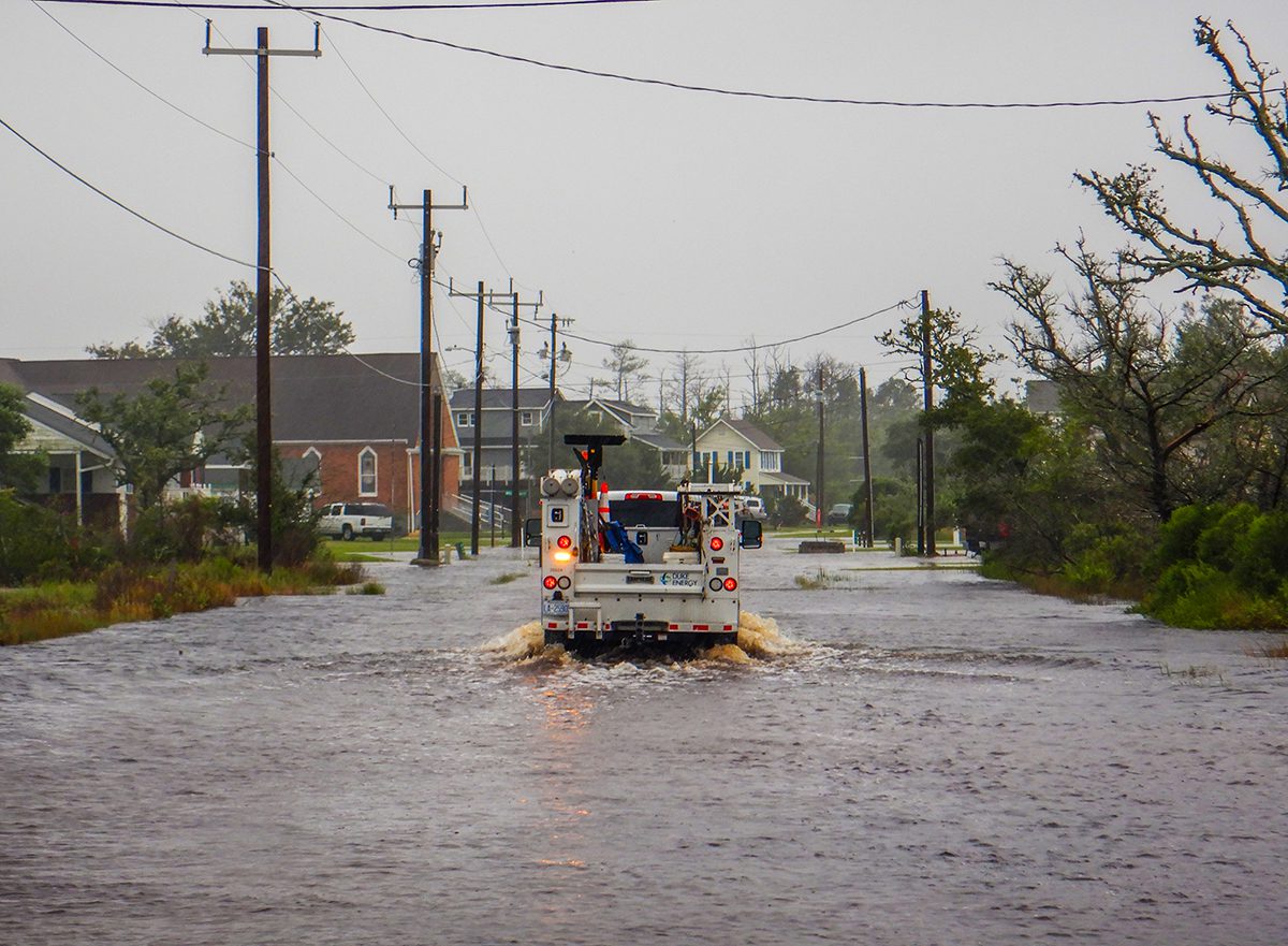 A Duke Energy truck is seen passing through floodwater along Community Road in Davis in Down East Carteret County as the effects of Tropical Storm Idalia in August 2023 on the North Carolina coast became clear the next morning. Photo: Dylan Ray 