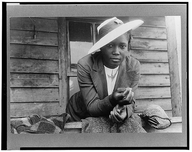 Migrant farm laborer in Belcross, N.C., 1940. She may be in her traveling clothes or headed to church; Delano did note that it was a Sunday. Photo by Jack Delano. Courtesy, Library of Congress
