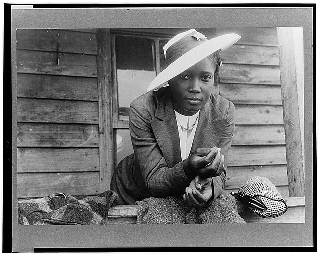 Migrant farm laborer in Belcross, N.C., 1940. She may be in her traveling clothes or headed to church; Delano did note that it was a Sunday. Photo by Jack Delano. Courtesy, Library of Congress

