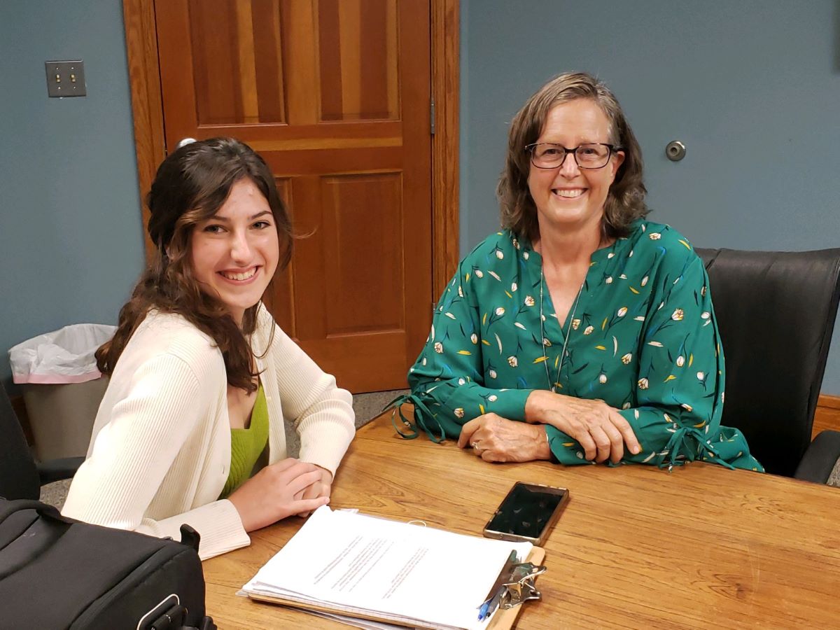 Tara Hinton, left, interviews for an oral history project past Carteret Long Term Recovery Alliance director, Robbie Phillips, earlier this summer. Photo: Core Sound