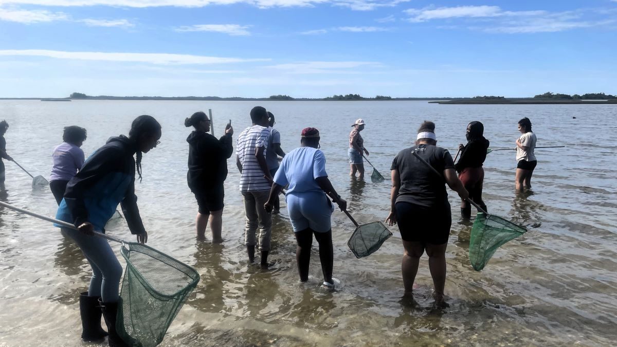 Dr. Caresse Gerald, fourth from left, takes a photo during a recent field trip to Carteret County with her students from N.C. Central University. Photo: N.C. Coastal Federation