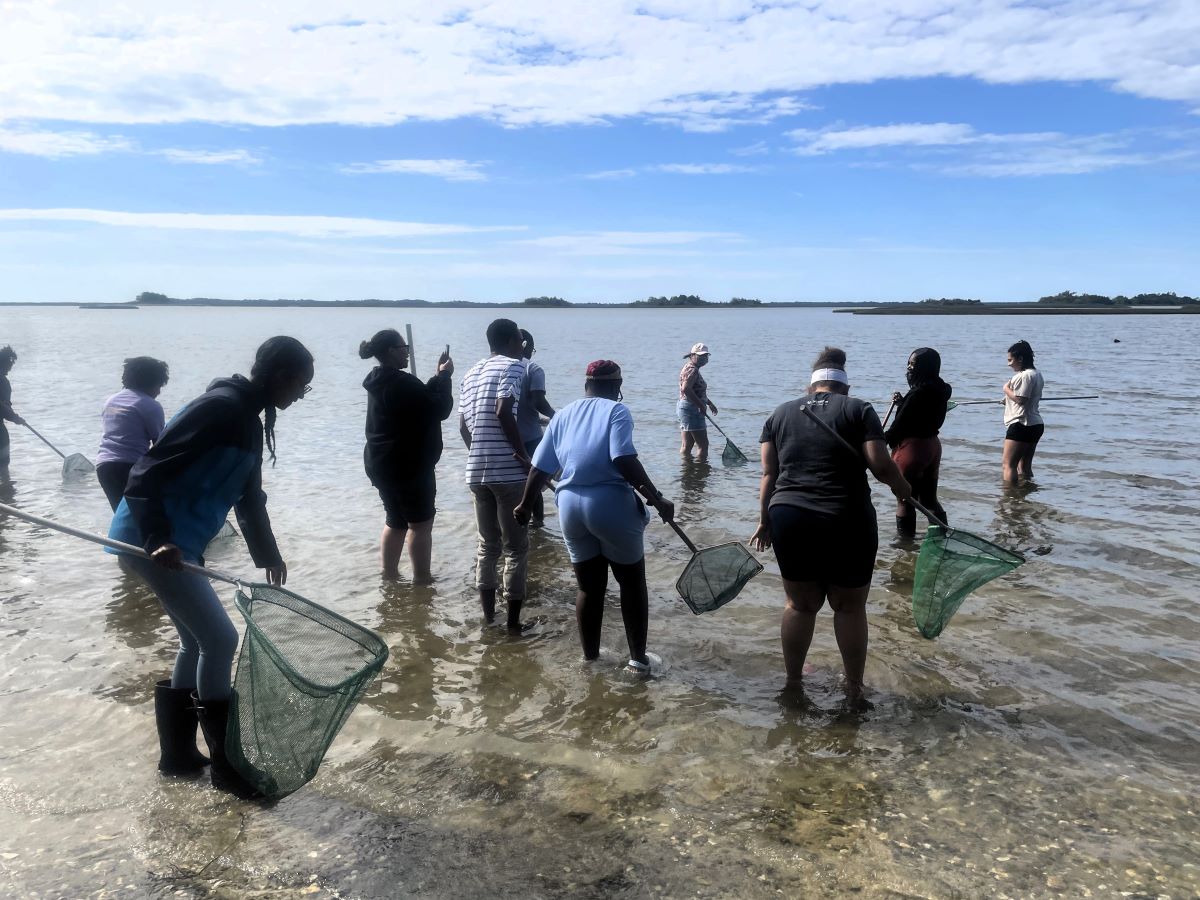 Dr. Caresse Gerald, fourth from left, takes a photo during a recent field trip to Carteret County with her students from N.C. Central University. Photo: N.C. Coastal Federation