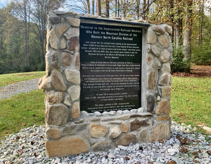 In one part of North Carolina, people have not forgotten the convict laborers who built so many of our state’s railroads. In 2020, volunteers in Buncombe and McDowell counties founded a non-profit group called The RAIL Project to remember the convict laborers that were forced to build the railroad through the Swannanoa Gap in Western NC. Their efforts led to the erection of this memorial at Andrew’s Geyser in Old Fort, N.C. The group is now working to identify grave sites of convict laborers who died on the mountain and erect informational panels about them. Photo by Fred McCormick. Courtesy, The Valley Echo
