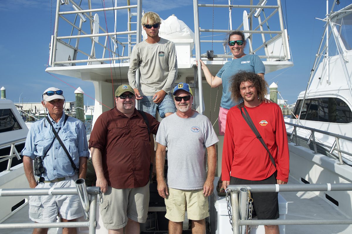 Kate Sutherland, top right, poses with the crew of the Stormy Petrel ii: front row, from left, Jeff Effinger, Chris Sloan, Capt. Brian Patteson, Sage Church and, top left, Daniel Irons. Photo: Kip Tabb