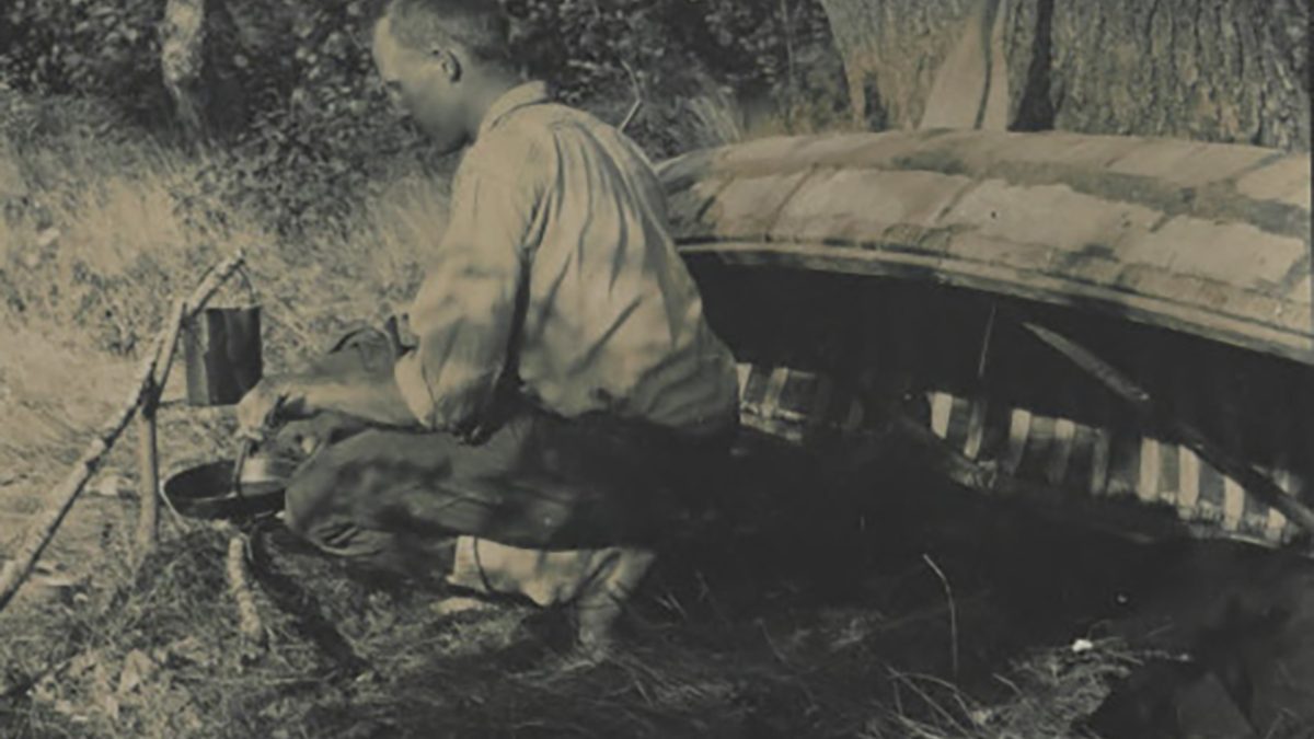 Frank Stick tends a campfire alongside his canoe circa 1905-1915. Photo courtesy of the Maud Hayes Stick Collection at the Outer Banks History Center/N.C. State Archives