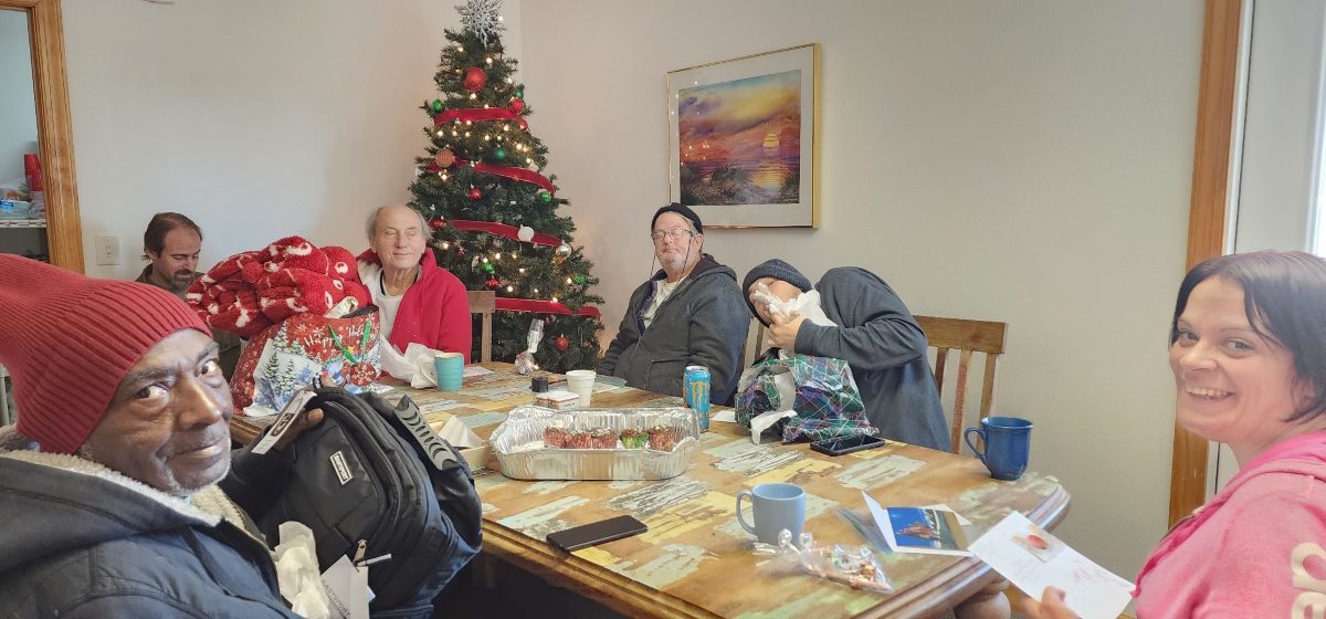 Guests of OBX Room In the Inn opening gifts during Christmas 2022. Photo: OBX Room in the Inn