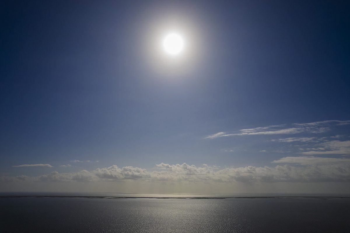 The bright morning sun reflects in the calm waters of Core Sound east of Marshallberg. Photo: Dylan Ray