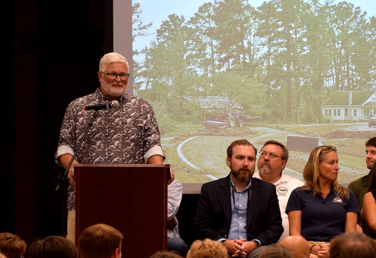 Harkers Island resident Corey Lawrence looks onto the crowd during the Sept. 12 Community Night at Core Sound Waterfowl Museum and Heritage Center on Harkers Island as representatives from state agencies look on. Photo: Mark Hibbs