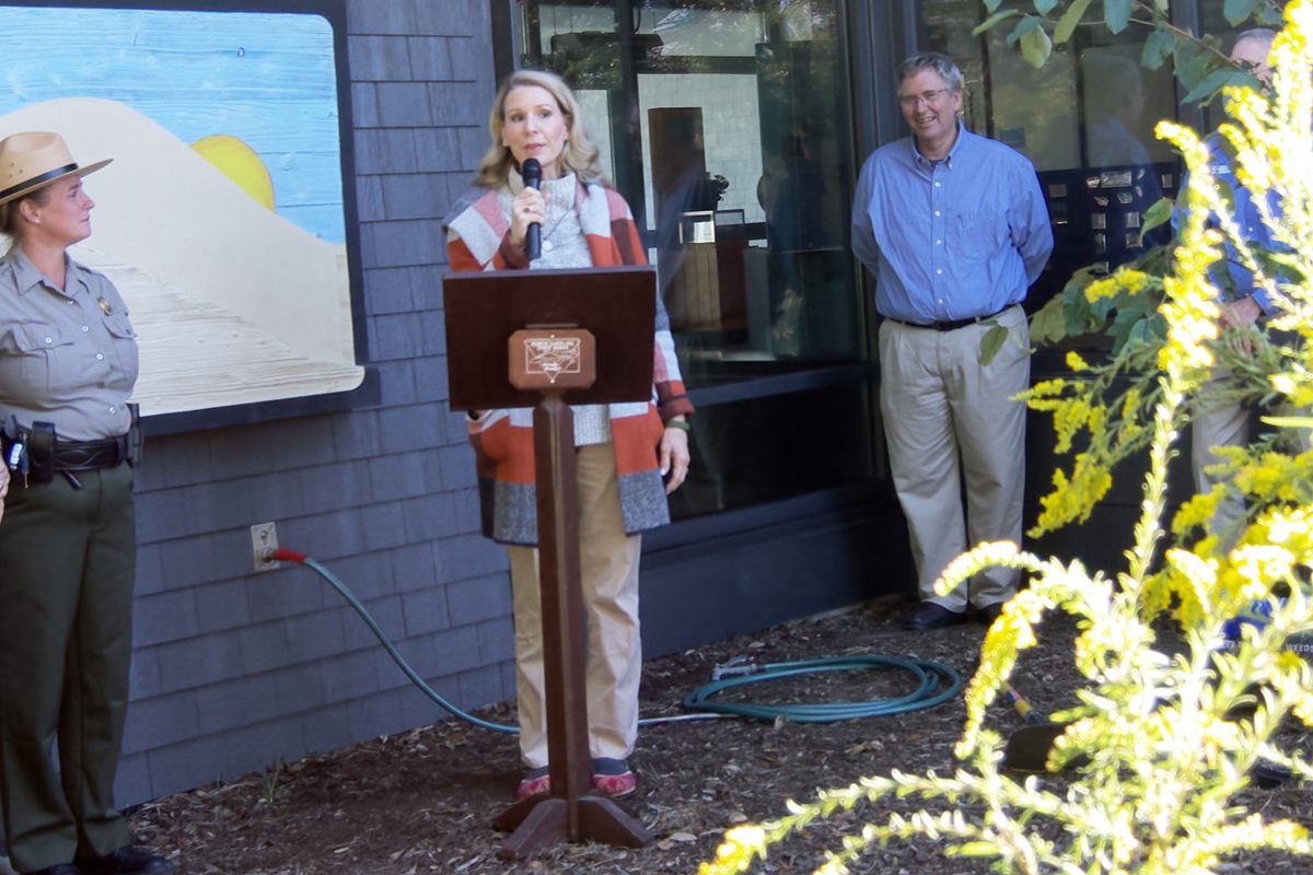 First Lady Kristin Cooper describes her experiences with native plants Wednesday at Jockeys Ridge State Park. Also shown are, from left, Jockey’s Ridge State Park Superintendent Joy Greenwood, Audubon North Carolina Executive Director Curtis Smalling, and, behind tree, North Carolina Department of Natural and Cultural Resources Secretary Reid Wilson. Photo: Kip Tabb