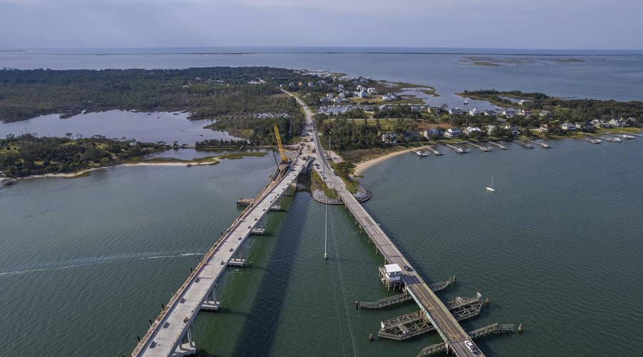 The Earl C. Davis Memorial Bridge, right, is still in use Wednesday as the only route for motorists on and off of Harkers Island, while construction continues on its replacement, in this photo by Dylan Ray