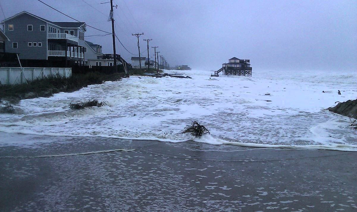 Kitty Hawk's oceanfront is shown not long after high tide while Hurricane Sandy was passing North Carolina Oct. 29, 2012, from the center line of N.C. 12, which is covered by sand, water and debris. Photo: NCDOT  