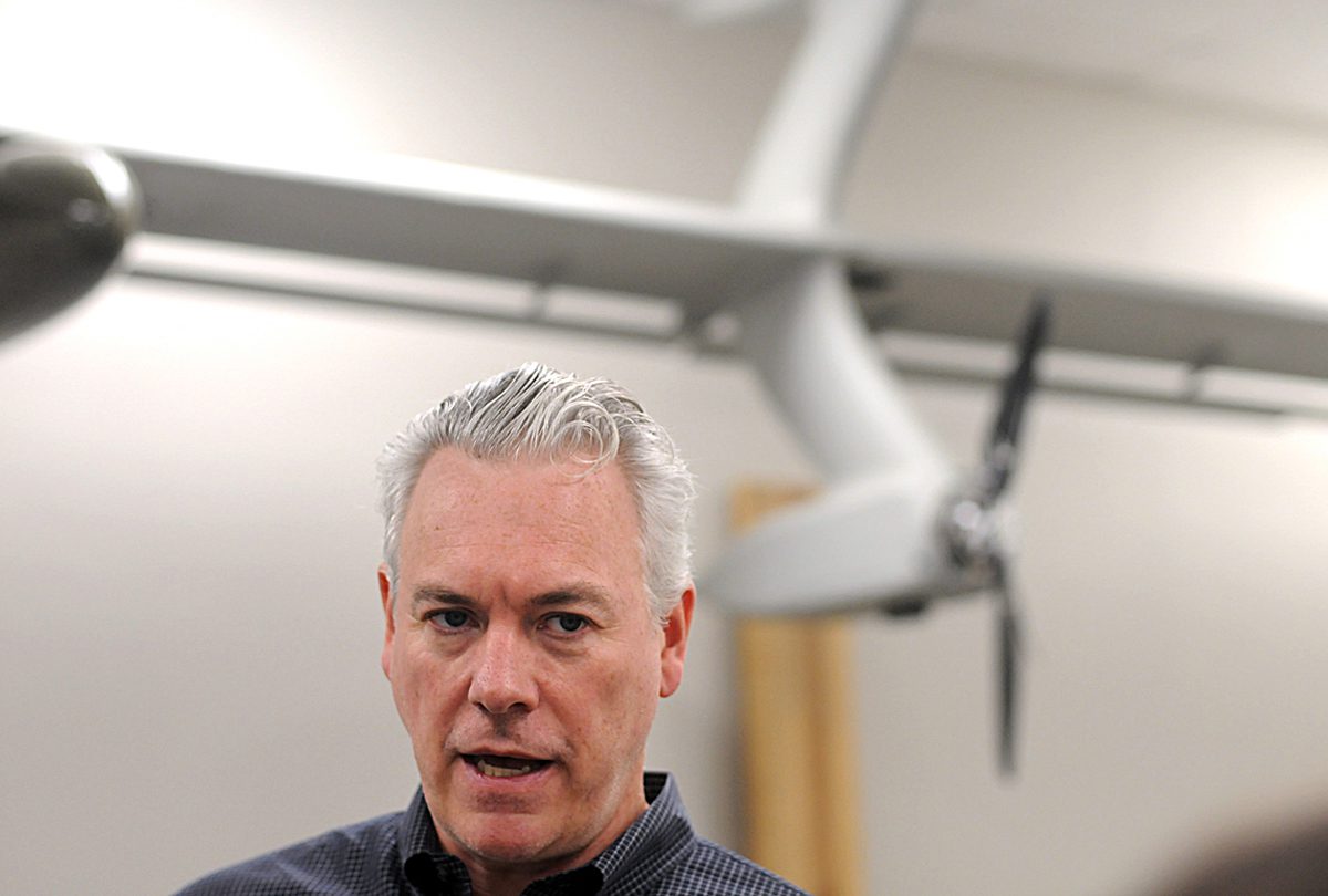 Windlift founder and CEO Robert Creighton gives a tour of the Durham, NC company facility with a 25-foot airborne power generator in the background. Creighton's company built the APG for the U.S. Marine Corps. Photo: Mark Courtney.