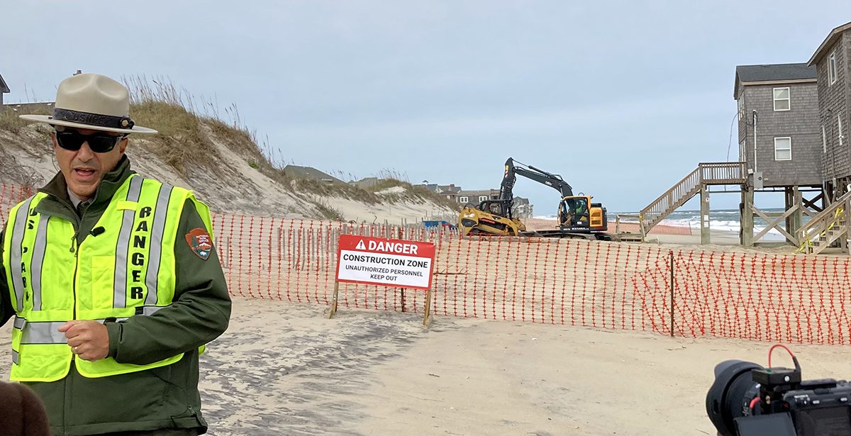 Cape Hatteras National Seashore Superintendent Dave Hallac speaks with the media as work commences on razing the house in the background. Photo: Catherine Kozak