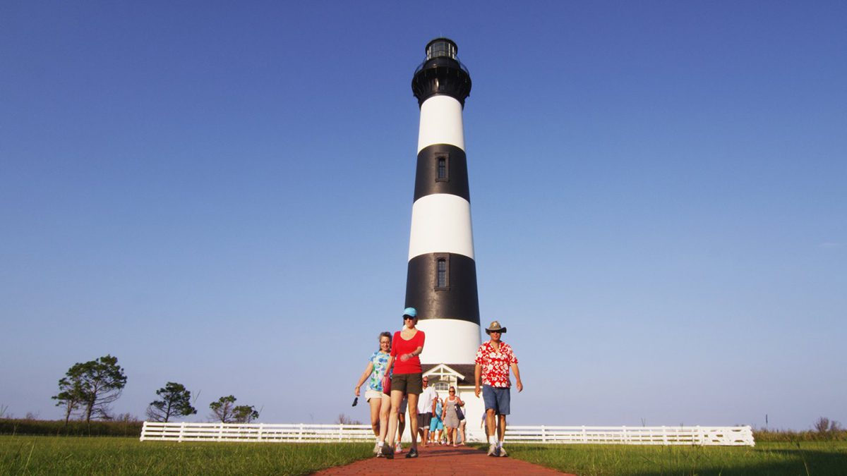 Vacationers are depicted at the Bodie Island Lighthouse in this outerbanks.org media photo.