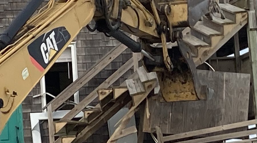 An excavating takes a chunk out of the house dismantled on the public beach Wednesday at the Cape Hatteras National Seashore. Photo: Catherine Kozak