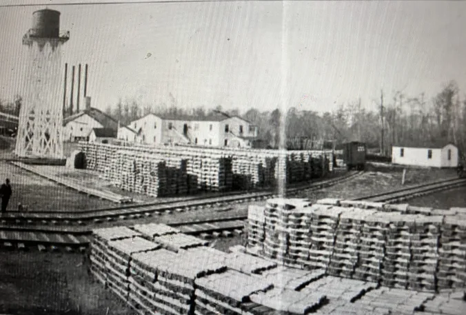 The John L. Roper Lumber Co.’s Atlantic white cedar (juniper) mill in Roper. The town of Roper was a lumber mill boomtown renown especially for this mill, said to be the largest cedar mill in the United States at that time. Moving left to right, we can see the mill’s water tower, power plant, the cedar sawmill, railroad cars, and the Norfolk & Southern’s spur that led into the mill. On the near side of the tracks, we can see stacks of cedar shingles and laths. Railroads were central to all lumber companies on the North Carolina coast at that time: to move its logs and lumber, the Roper Lumber Co. is estimated to have built somewhere between 150 and 200 miles of railroad. The Roper plant had the company’s only mills that relied entirely on railroads for log deliveries– at the company’s other mill sites, logs also arrived by water.  Roper, unlike so many of the lumber boom towns, has found new life and is an incorporated town today, though it has been a long time since it was as bustling as it was when the Roper Lumber Co.’s mill was still in business. American Lumberman, April 27, 1907.

