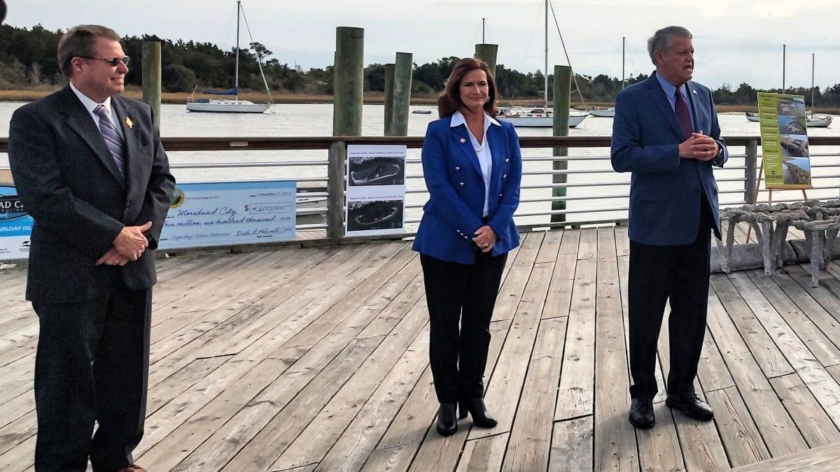 Sen. Norm Sanderson, R-Pamlico, right, who also represents Carteret County addresses Wednesday small crowd in downtown Morehead City to celebrate the start of the Sugarloaf Island restoration project as Mayor Jerry Jones, left, and Rep. Celeste C. Cairns, R-Carteret and Craven counties, look on. Photo: Jennifer Allen