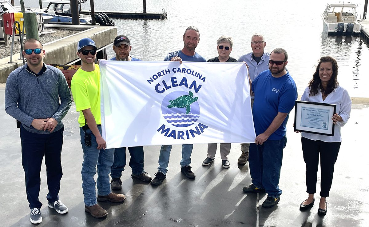 Ocean Isle Marine staff display the North Carolina Clean Marina flag. Photo: Division of Coastal Management