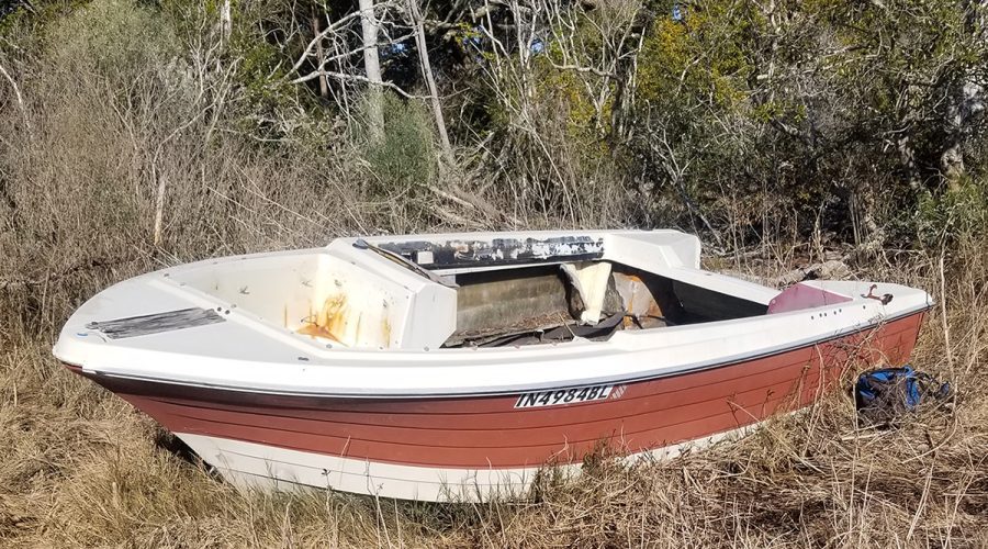 A pleasure craft rests in the marsh near Topsail Island before its removal in 2023. Photo: North Carolina Coastal Federation