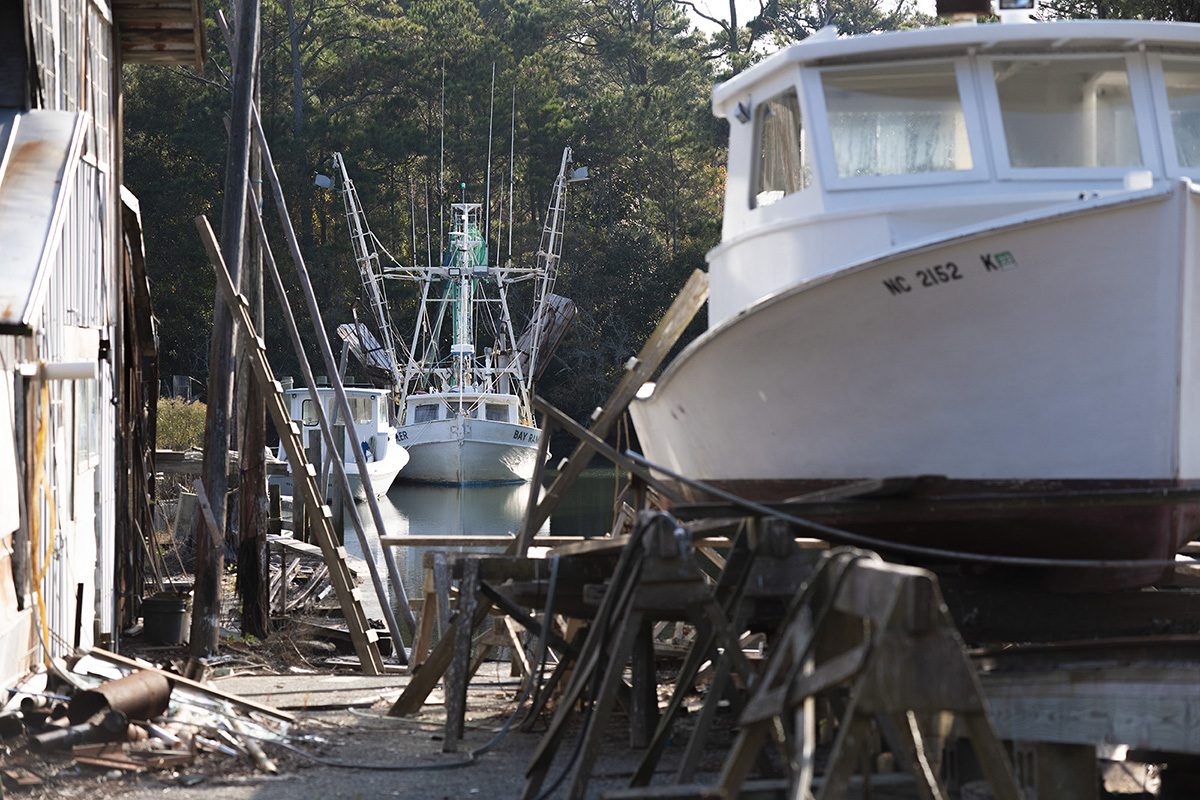 Fishing trawlers are protected from recent strong winds in a boatyard on the Sleepy Point peninsula between Gloucester and Marshallberg in Down East Carteret County. Photo: Dylan Ray