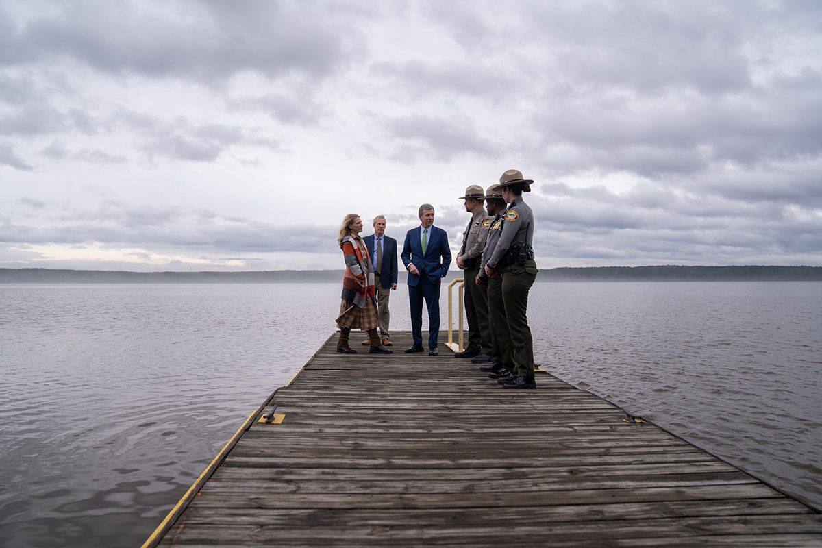 Gov. Roy Cooper, his wife Kristin and state Department of Natural and Cultural Resources Secretary Reid Wilson are shown with park rangers on a dock at the Rolling View Falls Lake Recreation Area in Durham. Photo: Governor's office