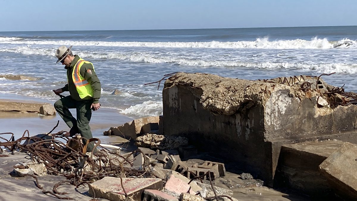 Cape Hatteras National Seashore Superintendent Dave Hallac investigates debris associated with the former Buxton Naval Base Feb. 14 on Lighthouse Beach. Photo: Catherine Kozak