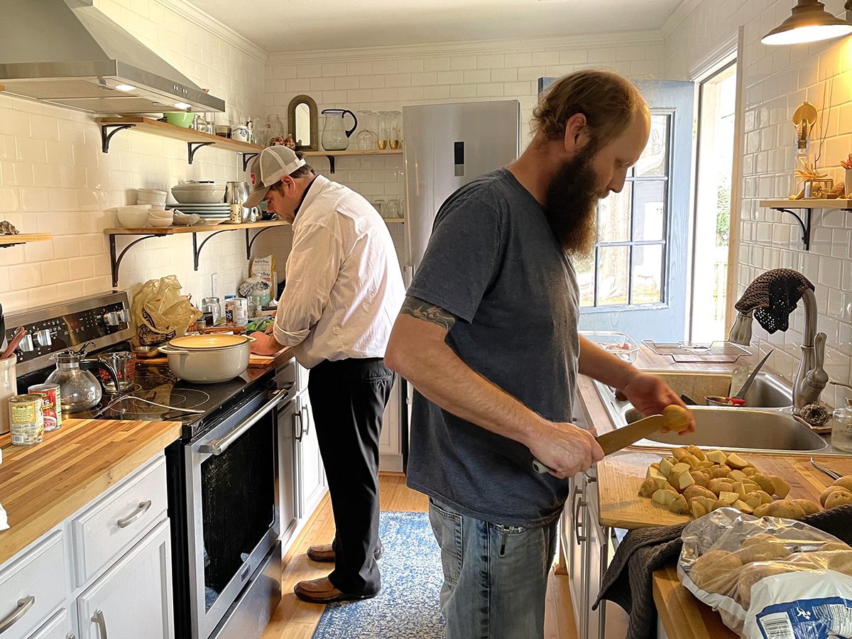 Trey Herring, left, and Steve Jolley prep potatoes and onions for fish stew. Photo: Liz Biro