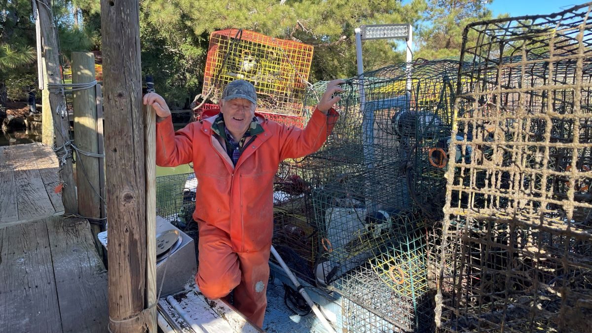 A crew member stands with pots collected during a previous Lost Fishing Gear Recovery Project. Photo: N.C. Coastal Federation