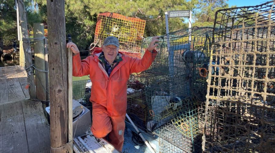 A crew member stands with pots collected during a previous Lost Fishing Gear Recovery Project. Photo: N.C. Coastal Federation