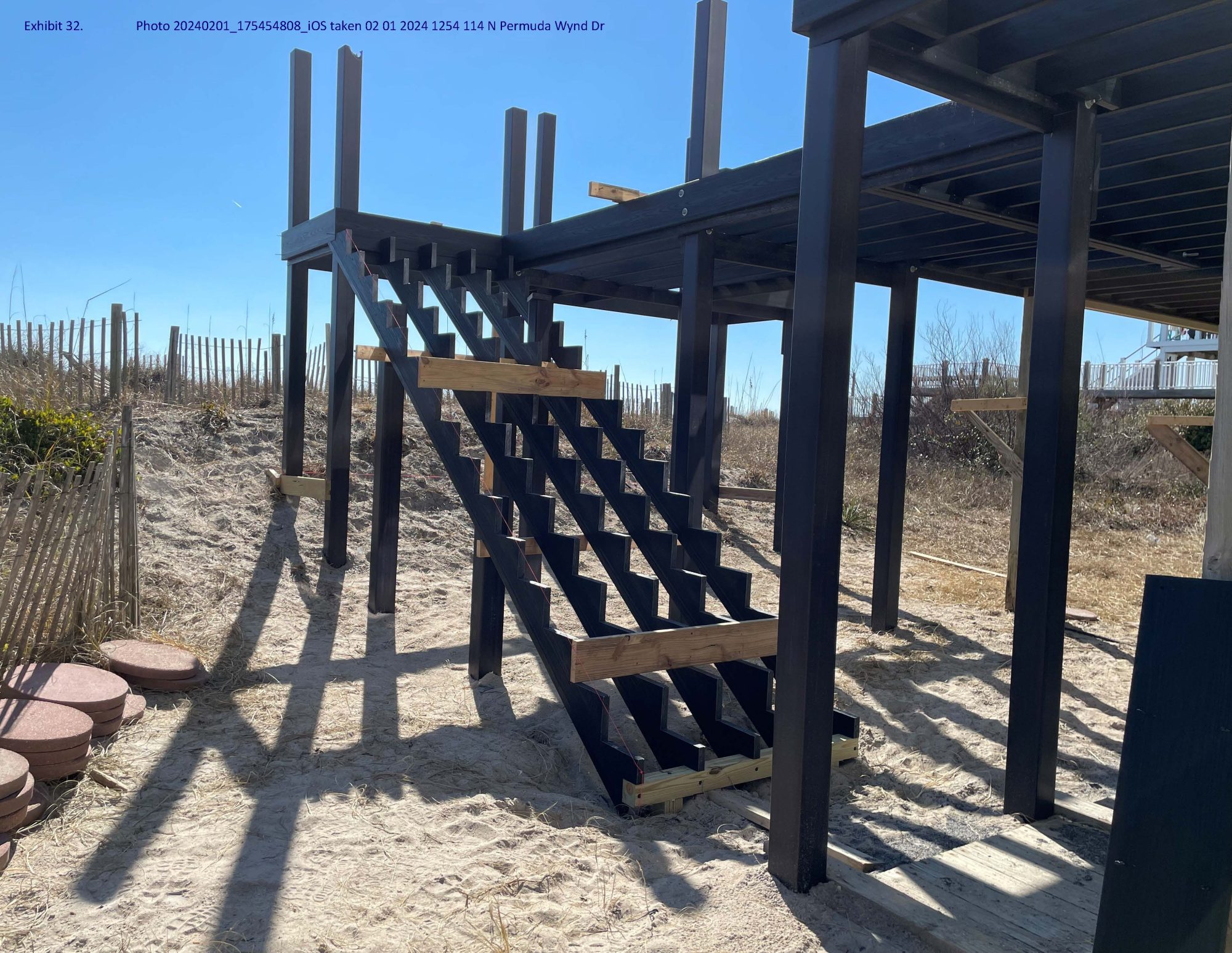Property owners Philip and Kristen Buckley are appealing a citation they received Feb. 1 that alleges their contractor, Coastland Construction LLC, violated North Topsail Beach’s development ordinance by installing deck pilings within the town’s 5-foot dune buffer zone. Photo: Town records
