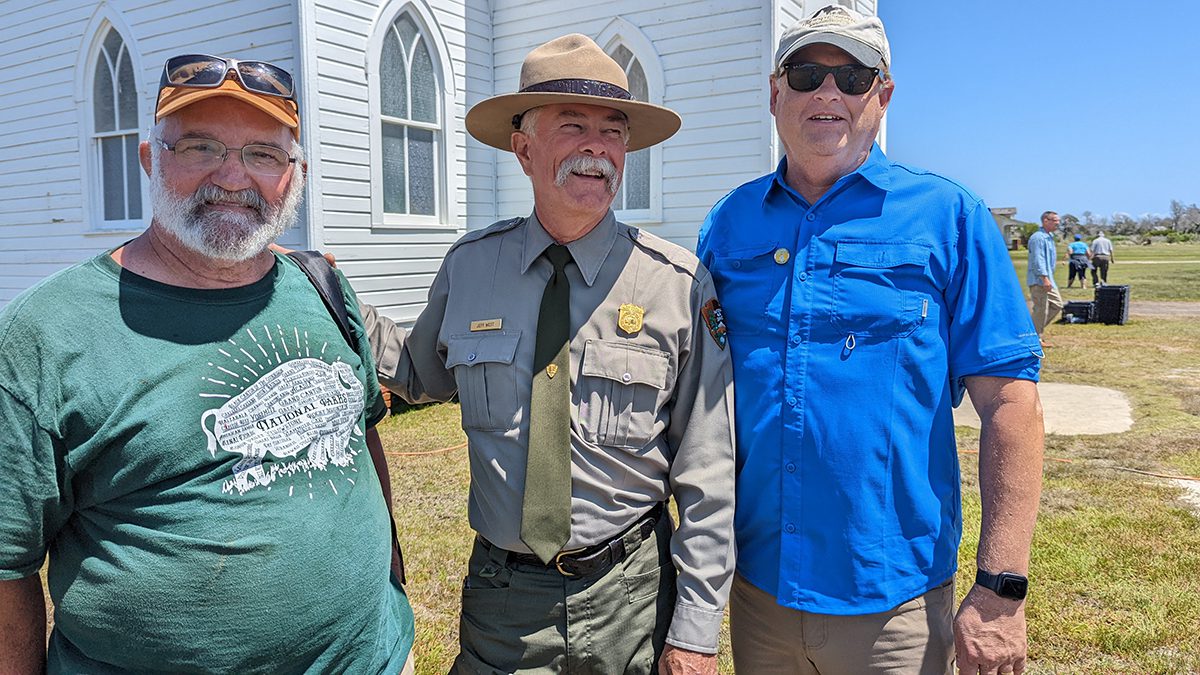 Former village caretaker Dave Frum, left, of Ocracoke, catches up with two of his former bosses, superintendents Jeff West and Bob Vogel, at the 2022 homecoming. Photo: P. Vankevich/Ocracoke Observer