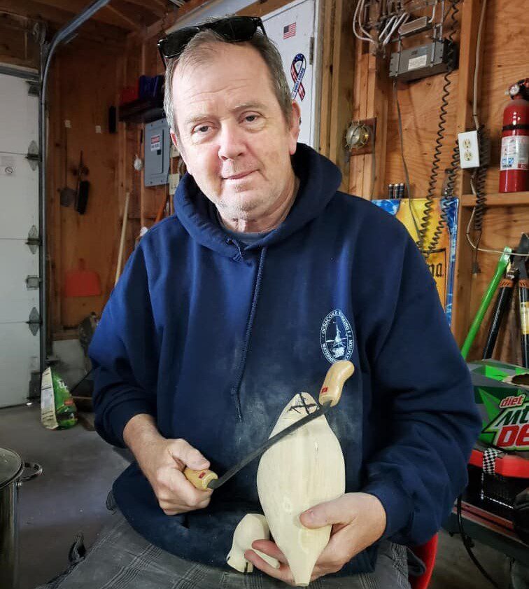 John Simpson works on decoys in this image from a past festival. Photo: Ocracoke Island Decoy Carvers Guild 