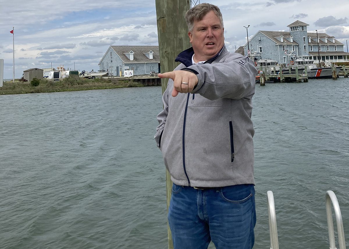 Oregon Inlet Fishing Marina Managing Operator Russell King on the transient deck, with the U.S. Coast Guard building in background. Photo: Catherine Kozak