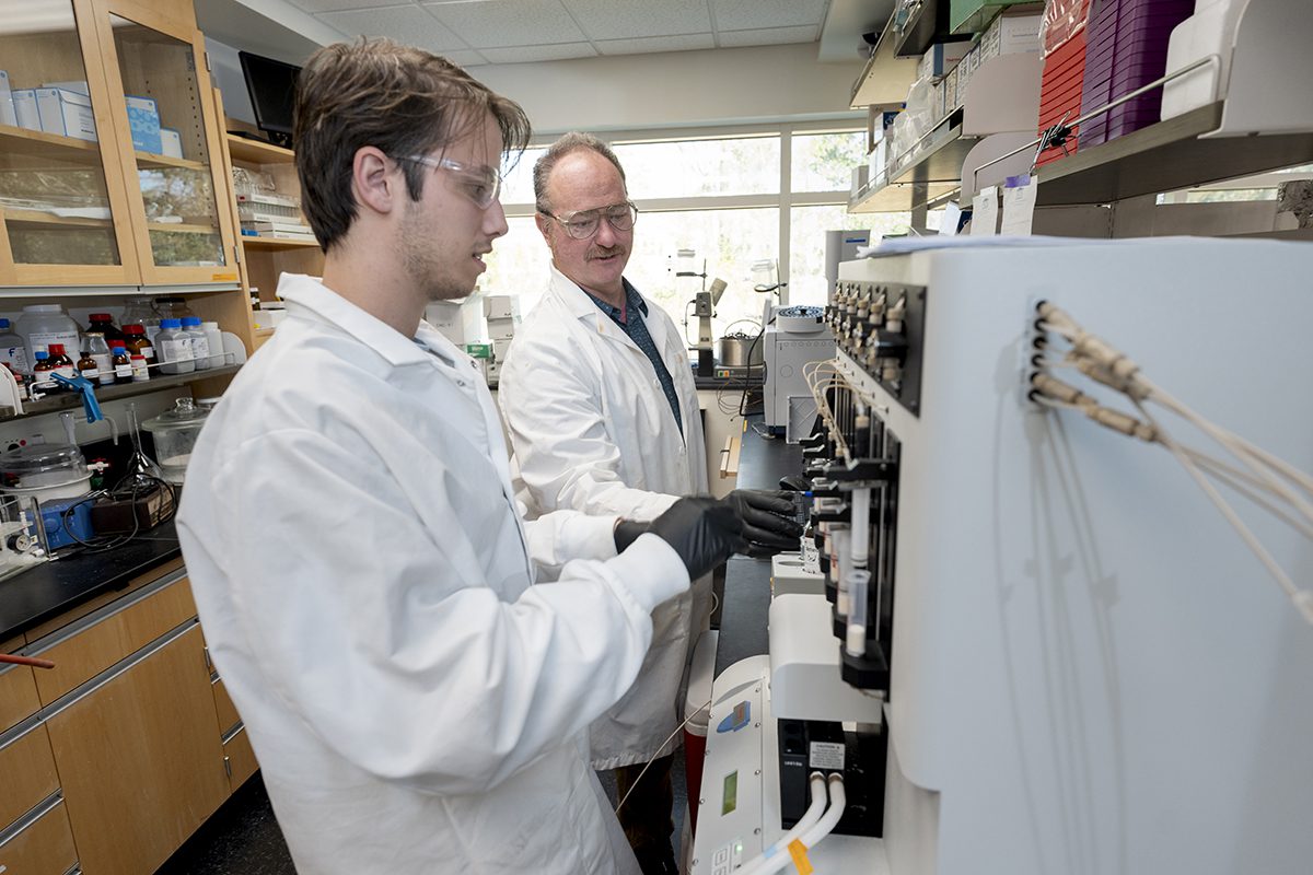 Ralph Mead, right, professor of chemistry and biochemistry for UNCW and Center for Marine Sciences, works with graduate student Justin Parker on PFAS samples at their research lab at Center for Marine Science. Photo: Jeff Janowski/UNCW