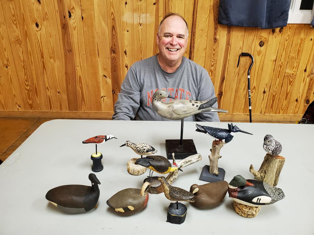 Vince O'Neal, the 2024 featured carver for the sixth annual festival, poses with some of his pieces. Photo: Ocracoke Island Decoy Carvers Guild