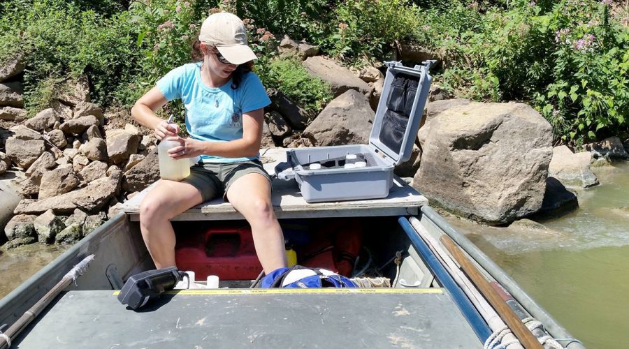 Madi Polera, a Ph.D. candidate attending North Carolina State University, takes water samples and physical measurements for cyanobacteria upstream of Lock and Dam #1 in the Cape Fear River in 2015. Photo: Contributed