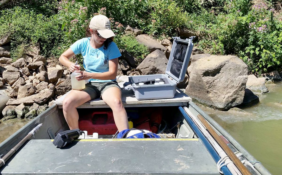Madi Polera, a doctoral candidate attending North Carolina State University, takes water samples and physical measurements for cyanobacteria upstream of Lock and Dam No. 1 in the Cape Fear River in 2015. Photo: Contributed 