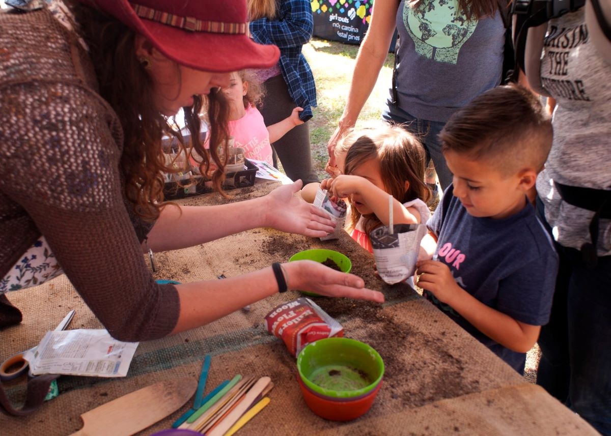 Young attendees participate in a planting project at a past The Wilmington Earth Day Festival. Photo: Wilmington Earth Day Alliance