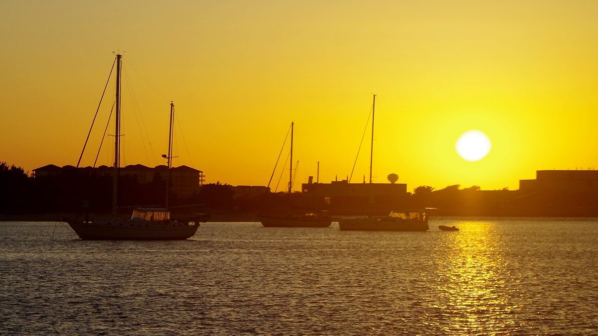 The sun plunges toward the horizon -- and Pivers Island, home to the Beaufort NOAA Lab -- as captured recently from the Beaufort waterfront on Taylors Creek. Photo: Mark Hibbs