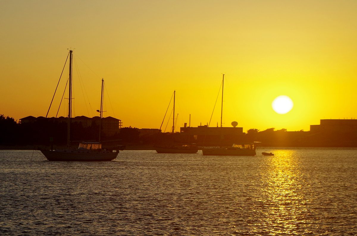 The sun plunges toward the horizon as captured recently from the Beaufort waterfront on Taylors Creek. Hotter days and nights are coming earlier than before in North Carolina. Photo: Mark Hibbs