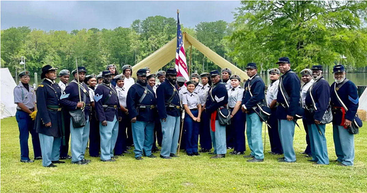 During the Commemoration, local Junior ROTC cadets visited with members of the 35th U.S. Reenactors Colored Troops, of New Bern, N.C., and the 2nd Regiment, U.S. Colored Light Artillery, Battery B, of Wilmington, N.C., at their encampment next to the Roanoke River. Photo: Sharon C. Bryant