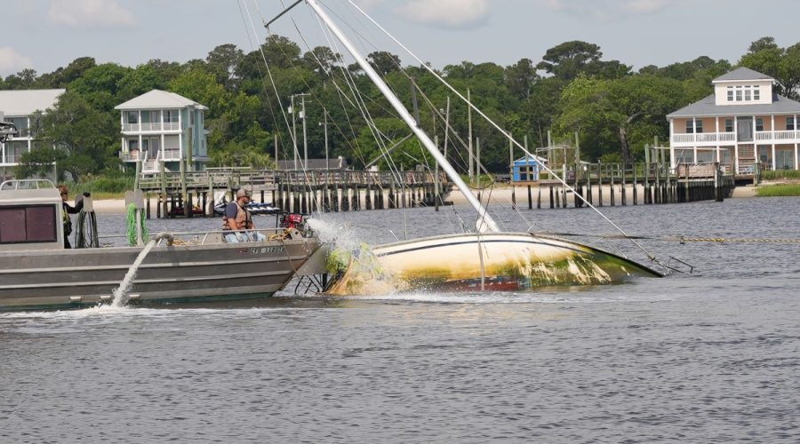 Crews work to remove an abandoned vessel near Carolina Beach Inlet. Photo: Stacia Strong
