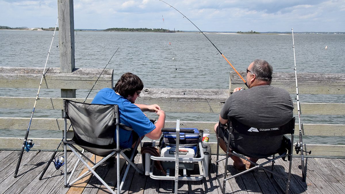 Two anglers try their luck Tuesday at the Newport River Pier on Radio Island in Morehead City. Photo: Mark Hibbs