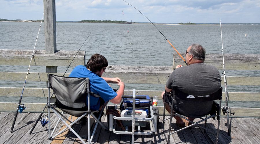 Two anglers try their luck Tuesday at the Newport River Pier on Radio Island in Morehead City. Photo: Mark Hibbs