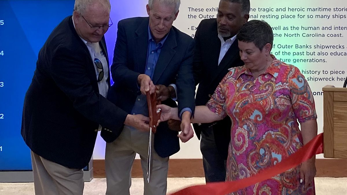 From left, Friends of the Graveyard of the Atlantic Museum President Danny Couch, North Carolina Department of Natural and Cultural Resources Secretary Reid Wilson, North Carolina Office of Archives and History Deputy Secretary Darin Waters and North Carolina Maritime Museums System Interim Director Maria Vann cut the ceremonial ribbon for invited guests Thursday during a preview at the Graveyard of the Atlantic Museum on Hatteras Island. Photo: Catherine Kozak