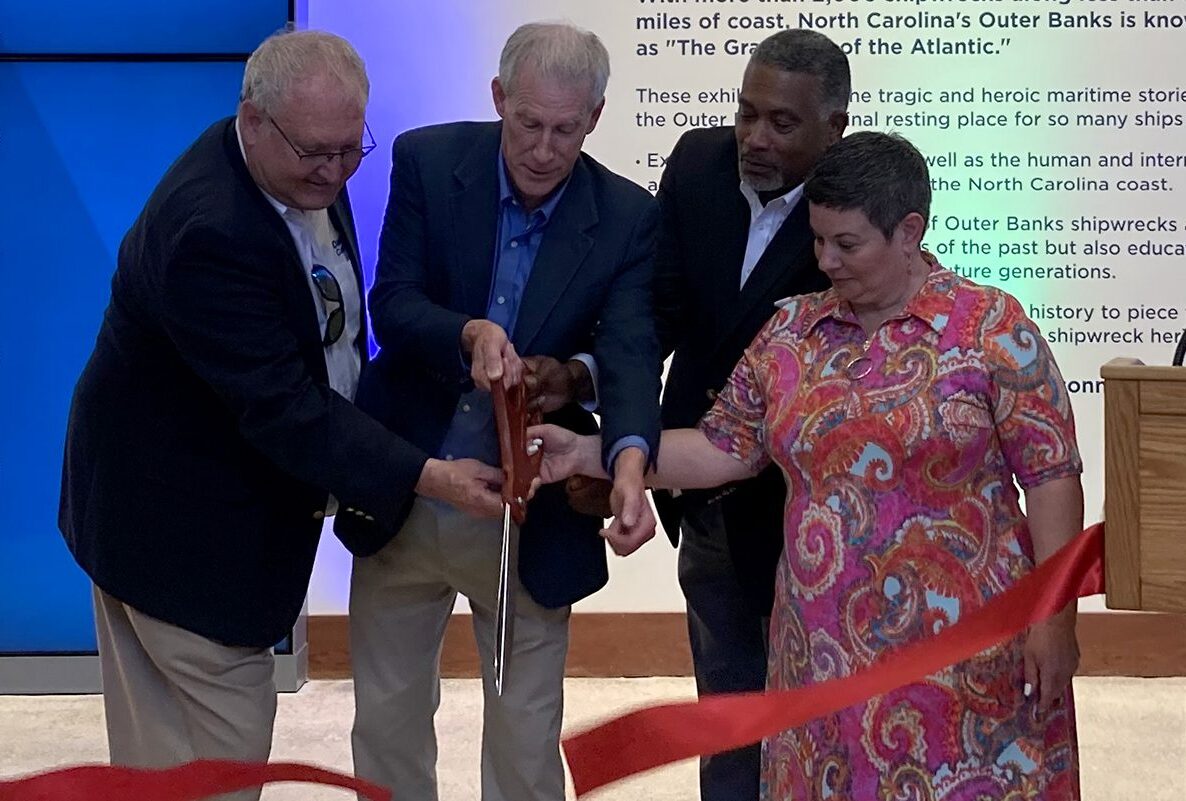 From left, Friends of the Graveyard of the Atlantic Museum President Danny Couch, North Carolina Department of Natural and Cultural Resources Secretary Reid Wilson, North Carolina Office of Archives and History Deputy Secretary Darin Waters and North Carolina Maritime Museums System Interim Director Maria Vann cut the ceremonial ribbon for invited guests Thursday during a preview at the Graveyard of the Atlantic Museum on Hatteras Island. Photo: Catherine Kozak