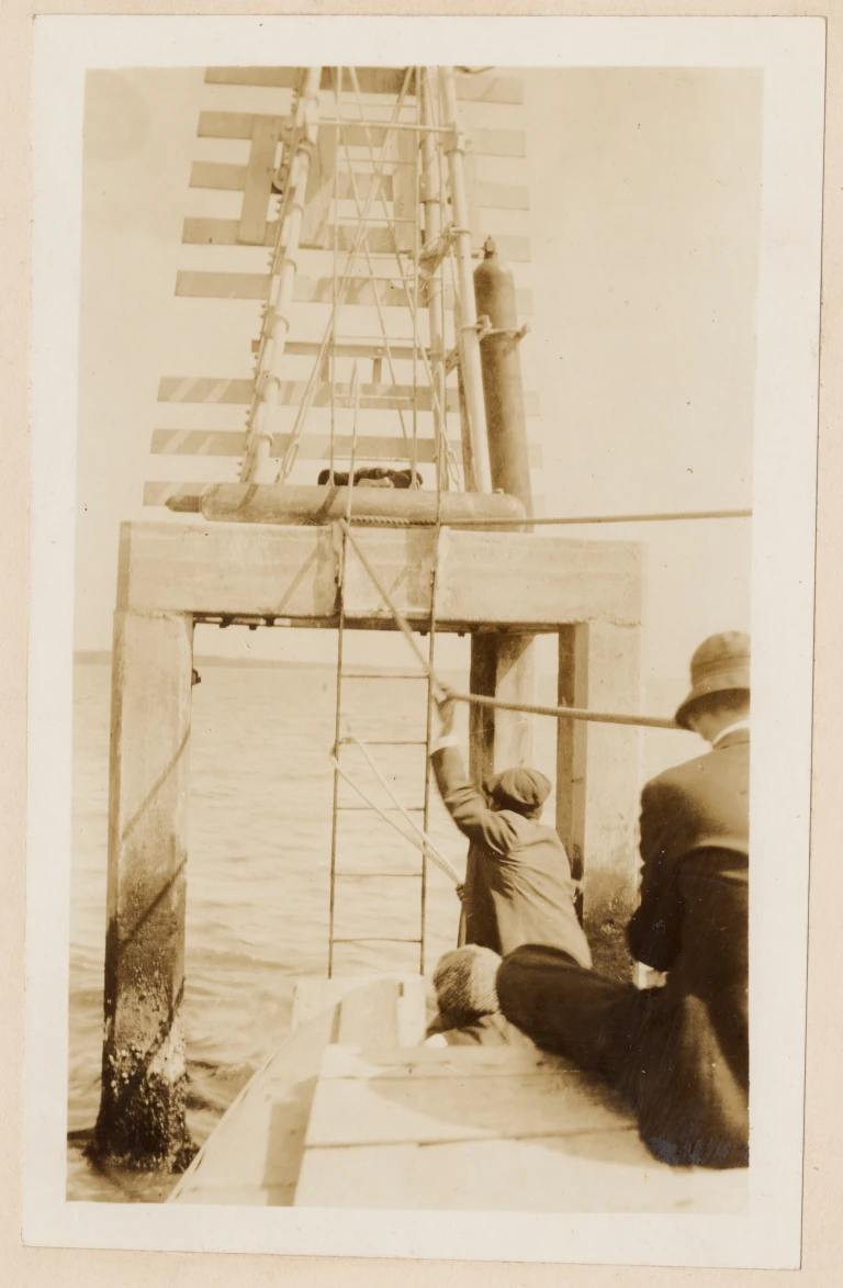 This photo, also dated May 1917, shows Keeper Berry and the crew of his keeper’s boat coming up on the light for Snow Marsh Channel and Reeves Point Channel on the Cape Fear River. (That section of the river runs roughly from Southport to the part of the river just west of what is now the Ft. Fisher Historic Site. )The USLS tender Palmetto had towed the boat up the Cape Fear, but had too great a draft to service at least some of the river’s lights without the use of the smaller craft. Source: Records of the U.S. Coast Guard (RG 26), National Archives- College Park (#45697830)

