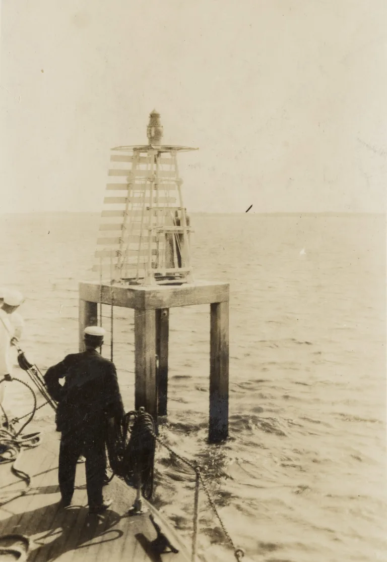 In this photograph, we see the U.S. Lighthouse Service tender Palmetto approaching the range light that marked Upper Midnight Channel on the Cape Fear River between Southport and Wilmington, May 1917. USLS Keeper Berry, in the foreground, was responsible for the maintenance of a series of post lights on the Cape Fear stretching 14 miles from Upper Liliput Channel all the way to the Atlantic. Source: Records of the U.S. Coast Guard (RG 26), National Archives-College Park (#45697828)

