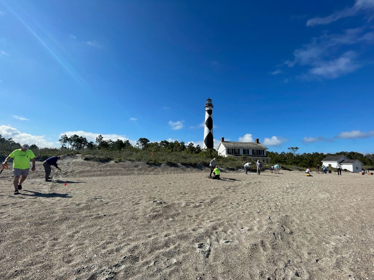 Volunteers plant dune grass in mid-May on the Cape Lookout Lighthouse beachfront, which has had about 30,000 cubic yards of dredge sand added over the last few months. Photo: Sabrina Godin/NPS