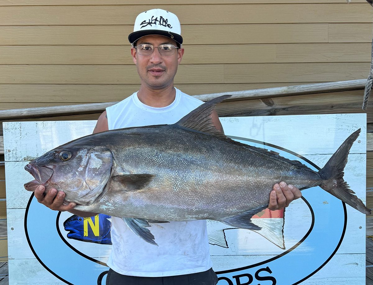Roberto Cancel III holds his state record almaco jack. Photo: Division of Marine Fisheries